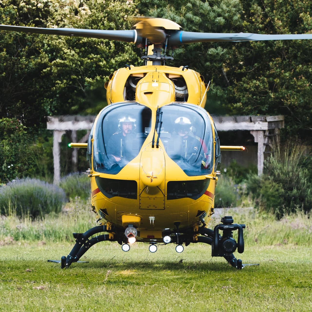 EAAA H145 helicopter landed on a grass field