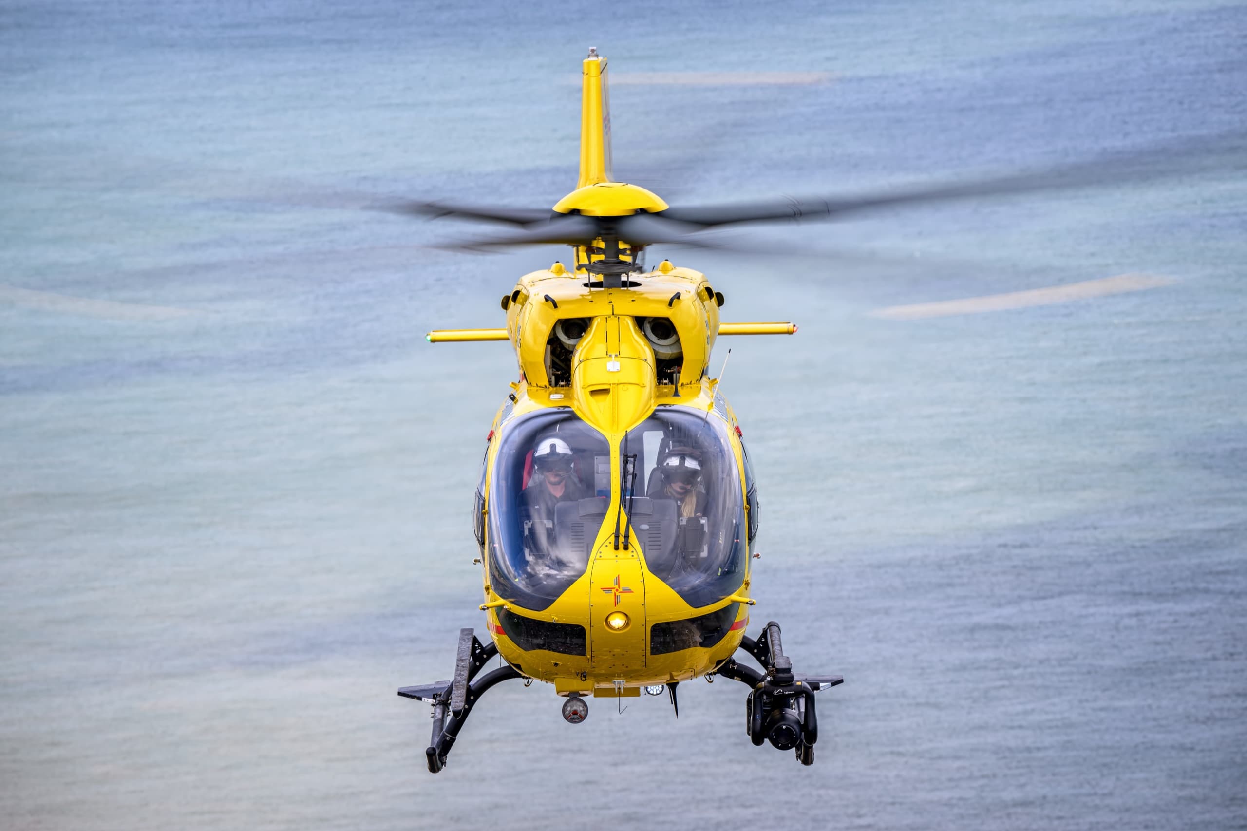 EAAA H145 helicopter in flight over water